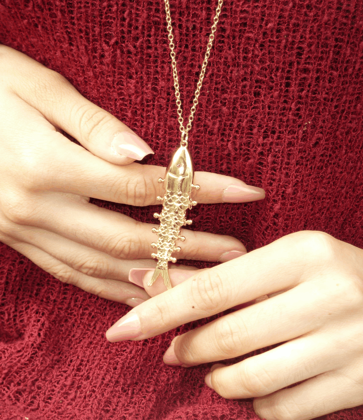 FIONA FISH NECKLACE with a gold-tone chain and long, textured fish-shaped pendant featuring raised details