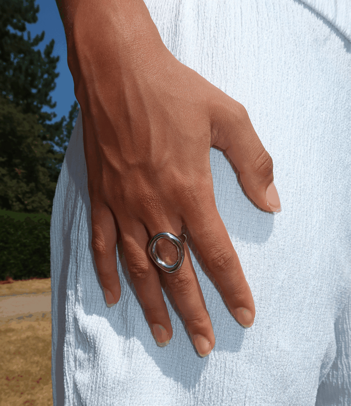 Chic Ring in polished silver-tone metal, featuring a chunky sculptural open oval design worn as a statement piece