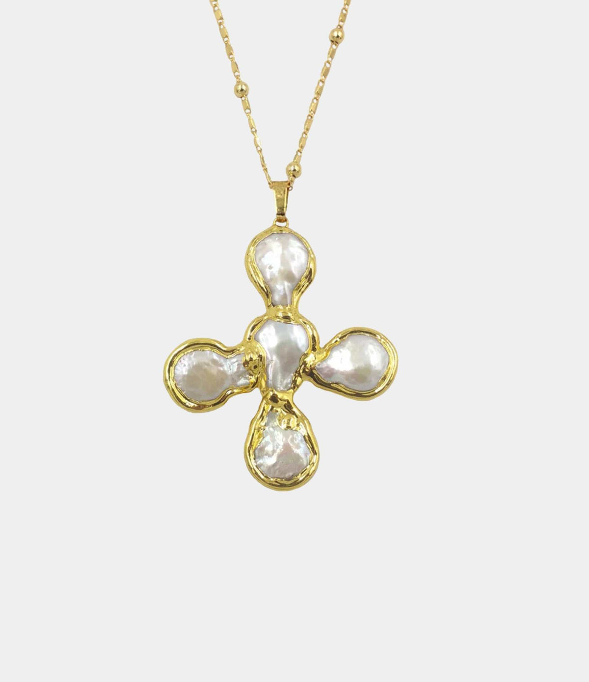 OLYMPIA NECKLACE with a gold-tone chain and a four-petal pendant featuring irregular white stones in gold settings.