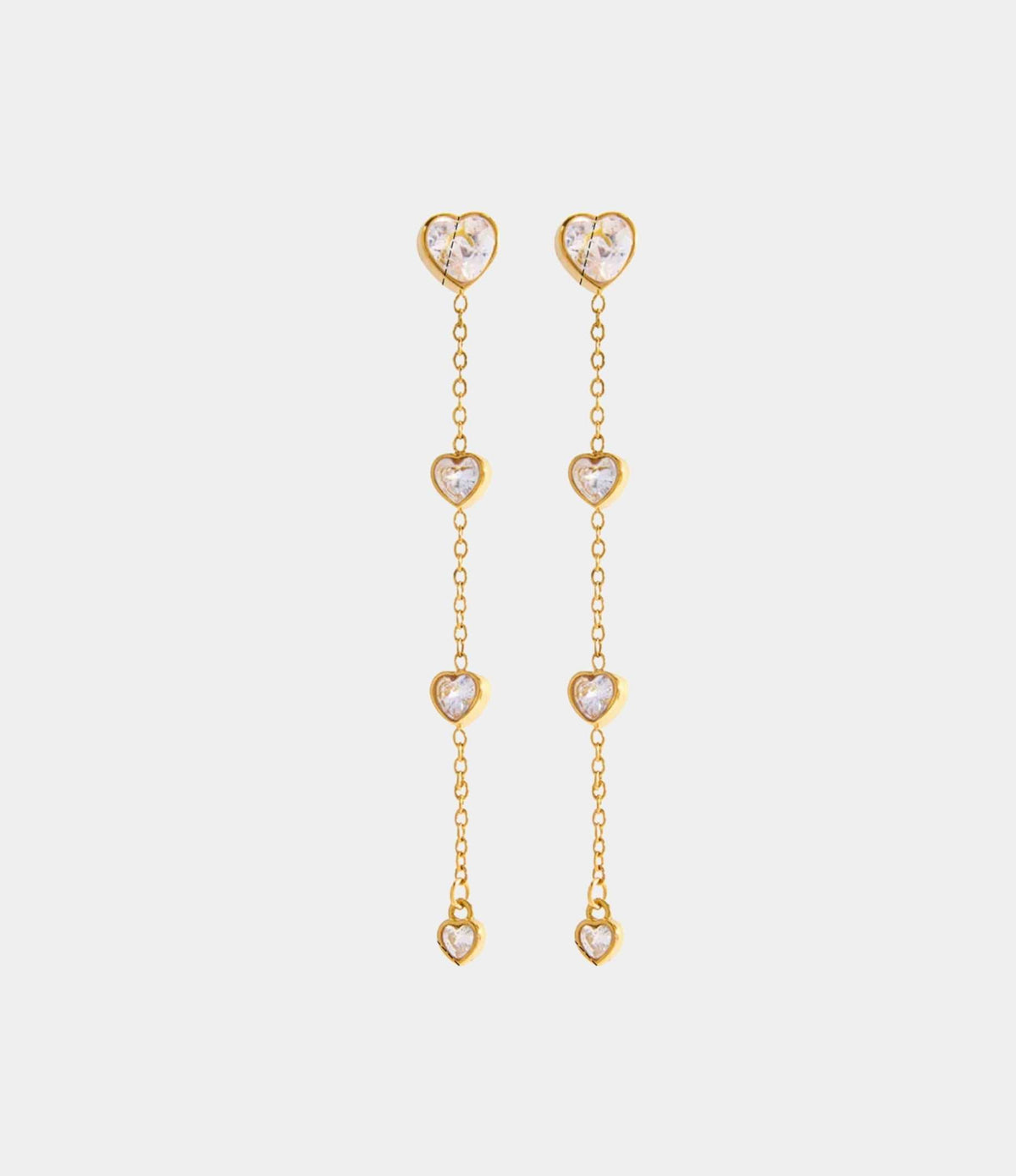 LOVE DROP EARRINGS in gold-tone metal, with long delicate chains and four clear heart-shaped stones on each earring.