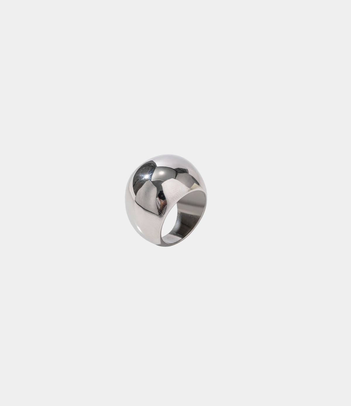 ANYA RING is a silver-tone stainless steel statement ring with a smooth, sculptural, rounded band.