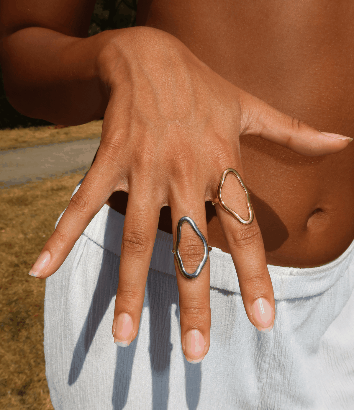 Blair Ring adjustable open-loop ring in gold-tone metal, shown beside a silver-tone ring with an organic outline
