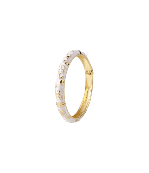 DAHLIA BANGLE IN SNOWDROP, gold-tone zinc alloy bangle with white enamel floral detailing and a hinged clasp.