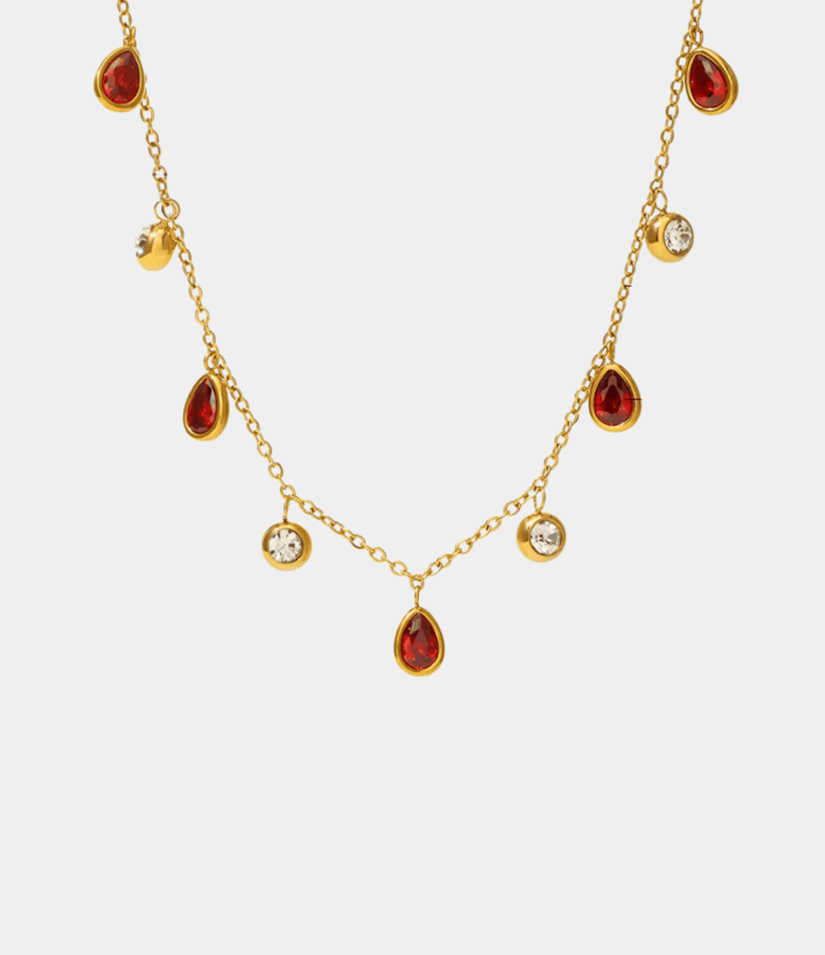 DIANA NECKLACE IN RED, delicate gold-tone chain with alternating red teardrop and clear round stones, finished with a central red pendant.