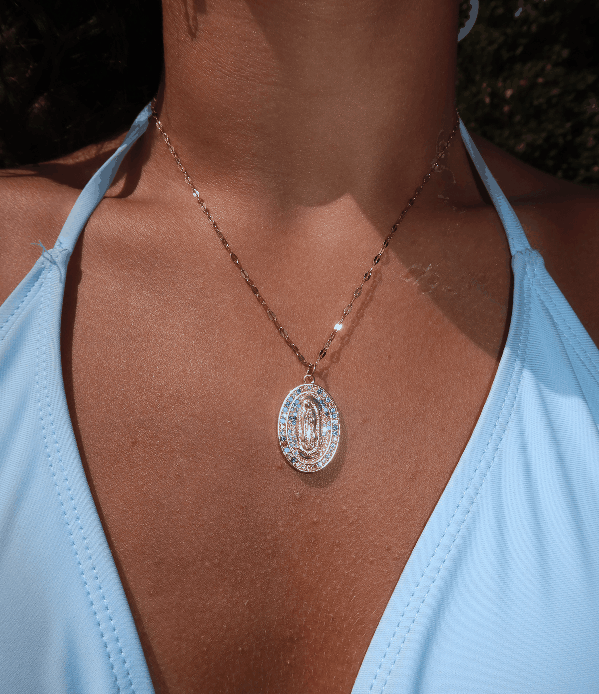 Divine Mary Necklace with a gold-tone fine chain and oval Holy Mary pendant featuring clear sparkling stone detailing