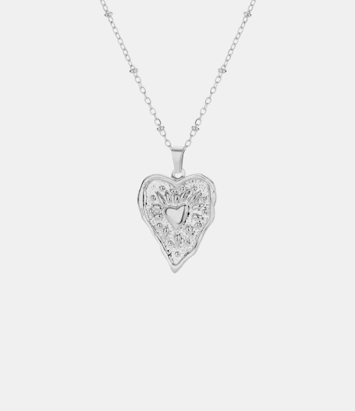 GRACE NECKLACE silver-tone chain pendant with an ornate heart-shaped design and small heart cutout