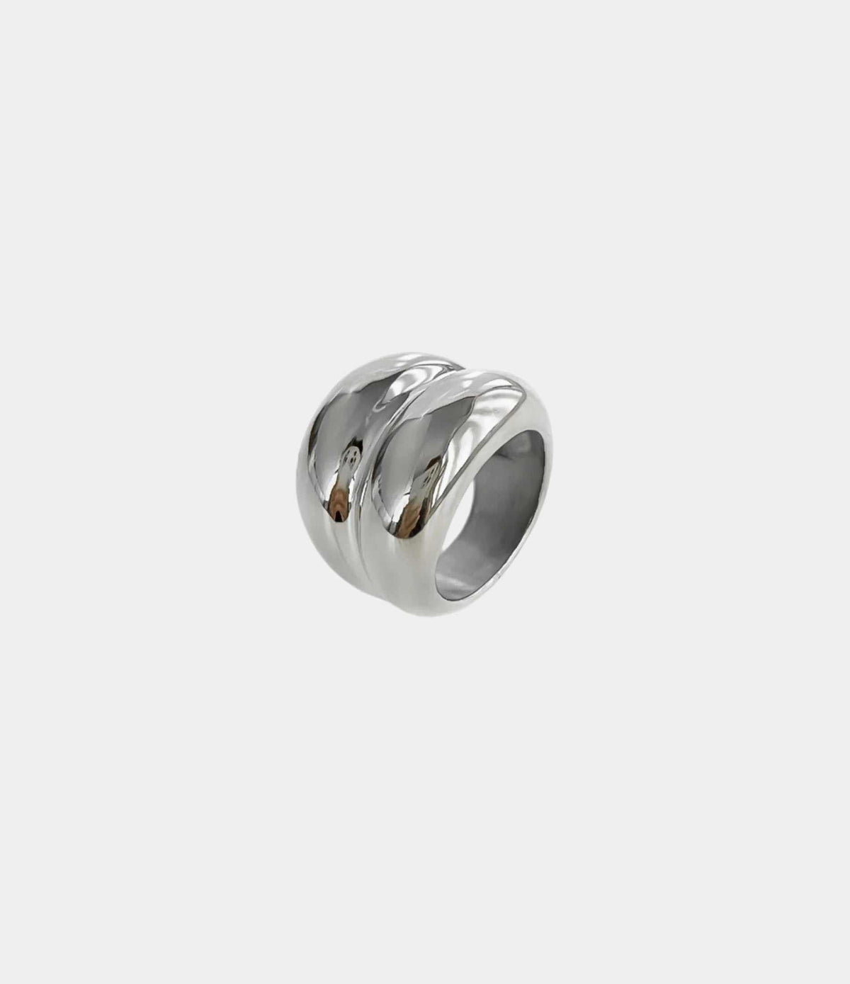 Maison Aurelle Ring in polished silver-tone metal, featuring a chunky sculptural band with flowing raised ridges