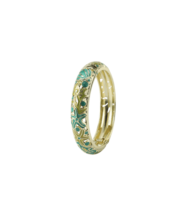 MERMAIDIA BANGLE IN JUNGLE, a gold-tone metal bangle with ornate green and turquoise enamel patterns and raised details.
