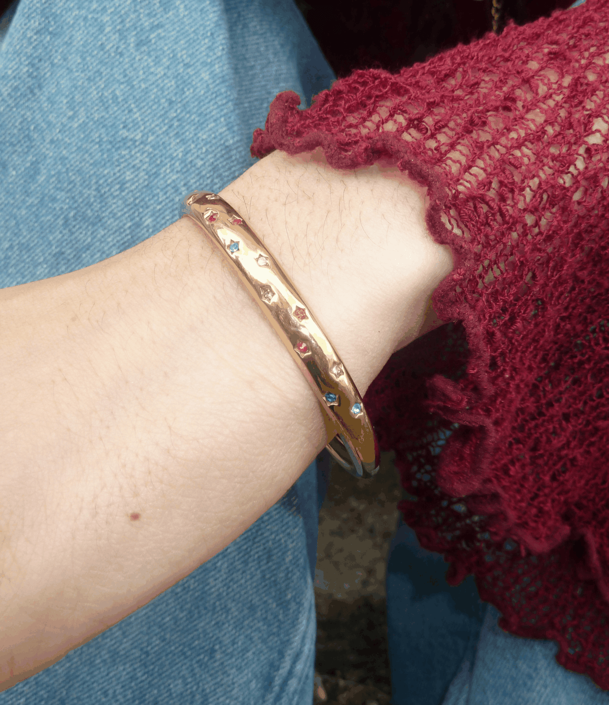 Olivia Bangle in Multicolour, a gold-toned slim bangle with small colourful decorative details along the band