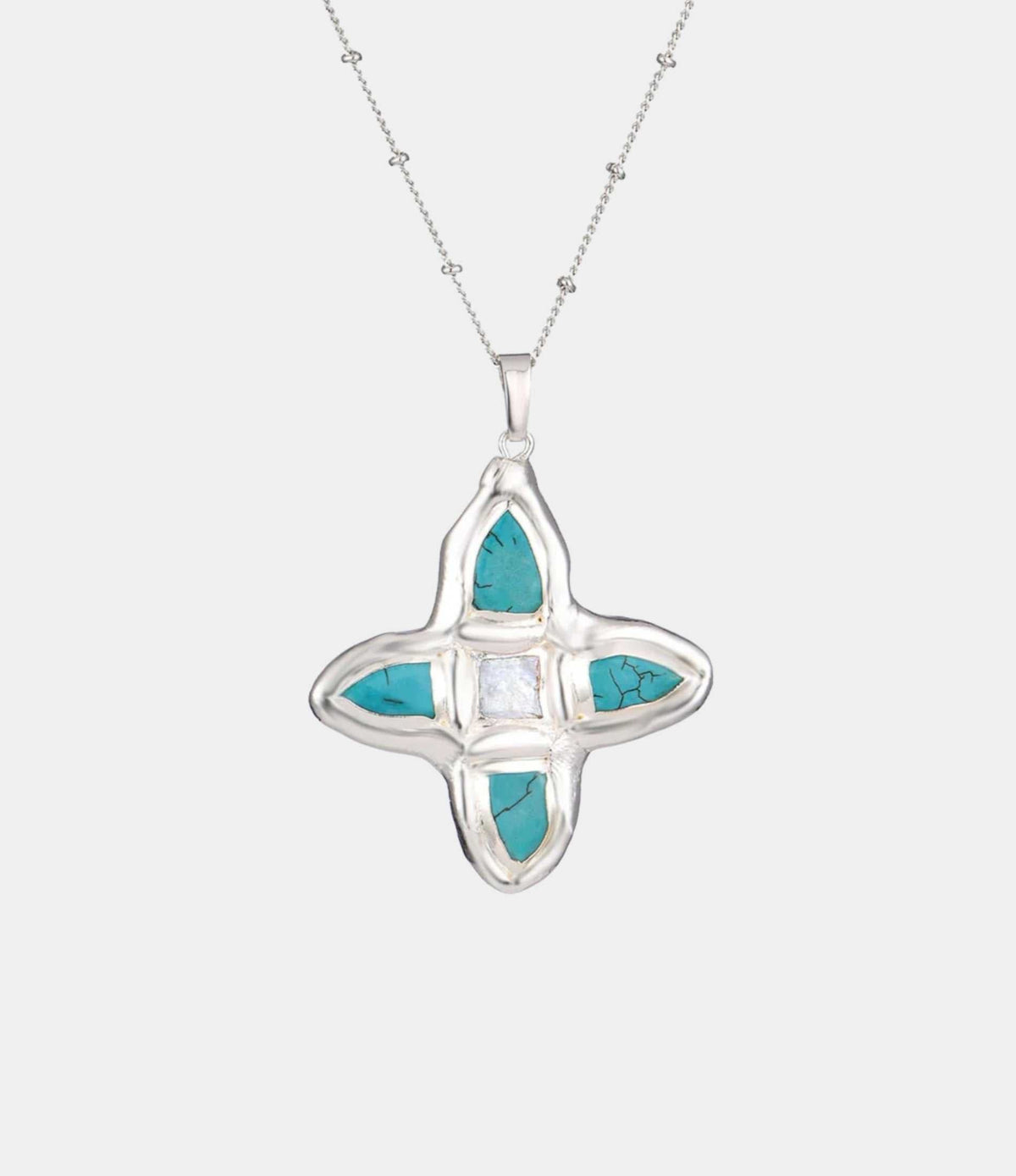 OPHELIA NECKLACE IN BLUE silver-tone chain necklace with a turquoise and pale stone cross pendant in a polished setting.