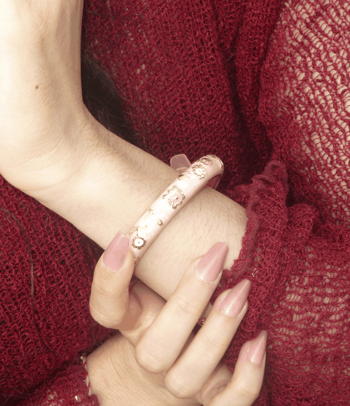 POPPY BANGLE IN PINK, glossy pale pink enamel bangle with delicate gold-toned floral detailing and a smooth finish.