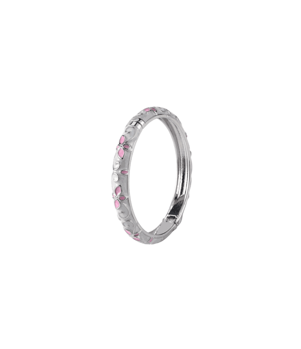 PRIMAVERA BANGLE IN SAKURA, a silver-tone metal bangle with white enamel, pink floral accents and delicate scrollwork.