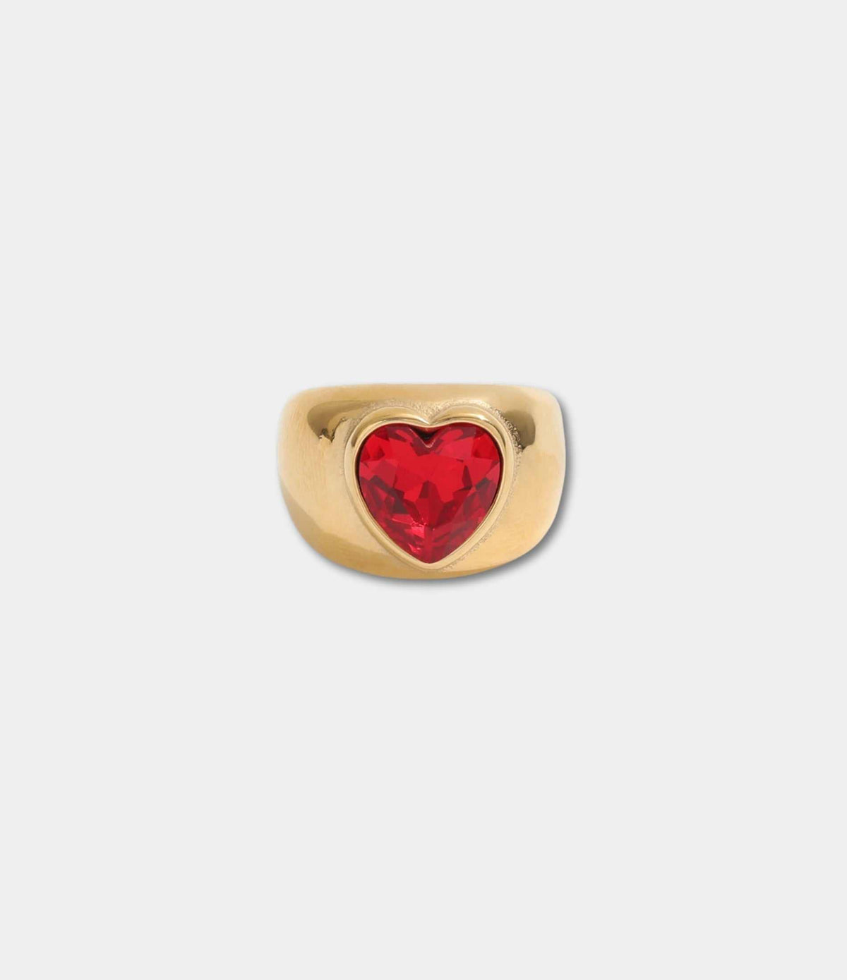 Gold-tone QUEEN OF HEARTS RING with a bold red faceted heart-shaped stone set in a wide polished band.