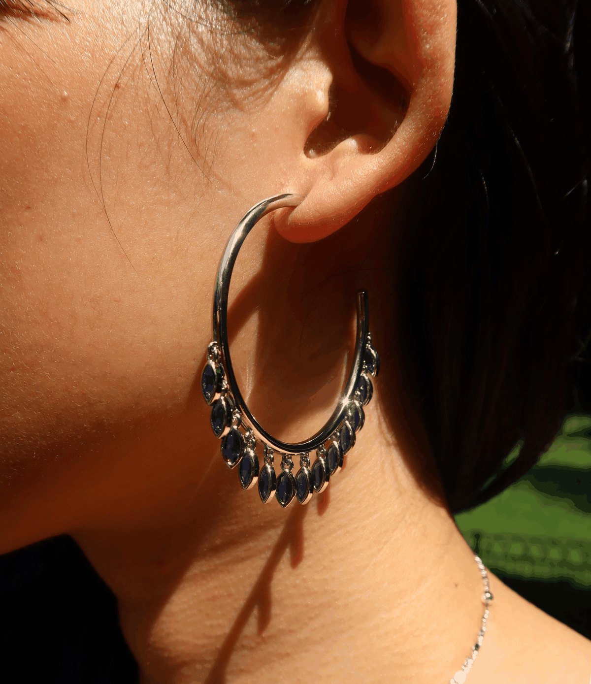 Vivian Earrings In Blue - 18ct Gold Plated Chunky hoop earrings with dangle details, silver-tone hoops with dark blue stones