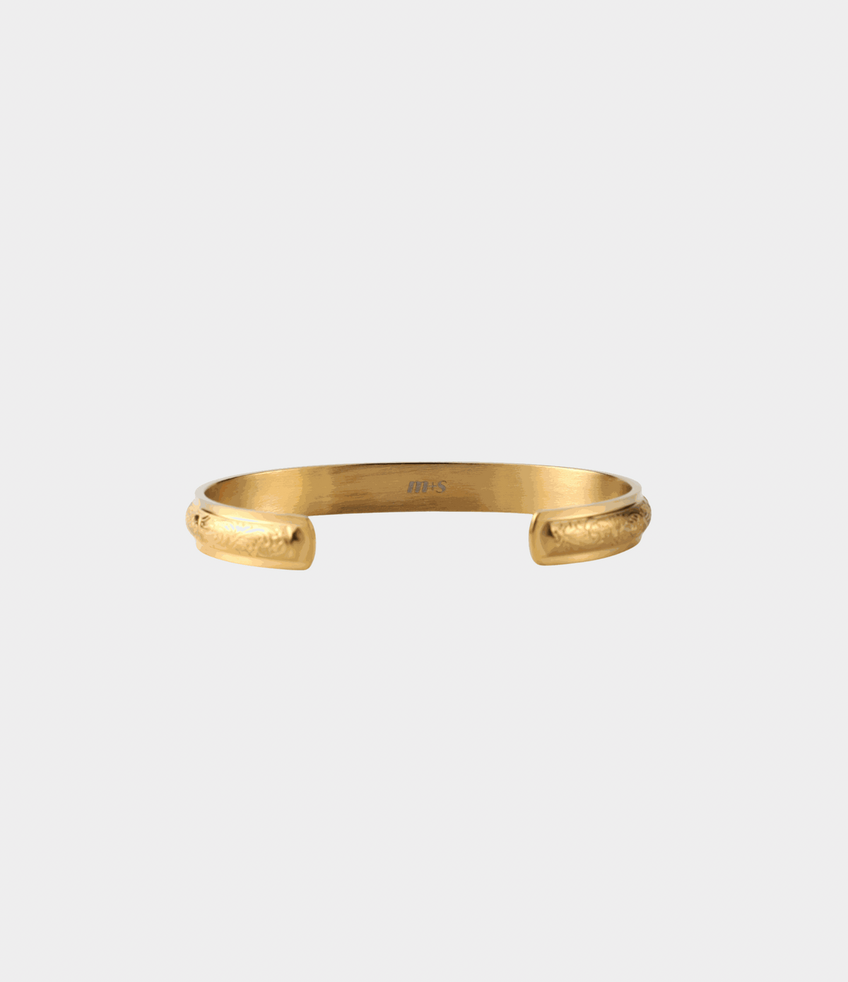 Adeline Bangle - Stainless steel bangle in gold tone with an open cuff, rounded ends and delicate engraved detailing.