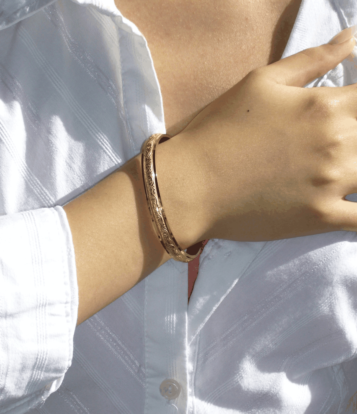 Adeline Bangle - Stainless steel bangle in gold-tone metal, with an open cuff and delicate engraved detailing