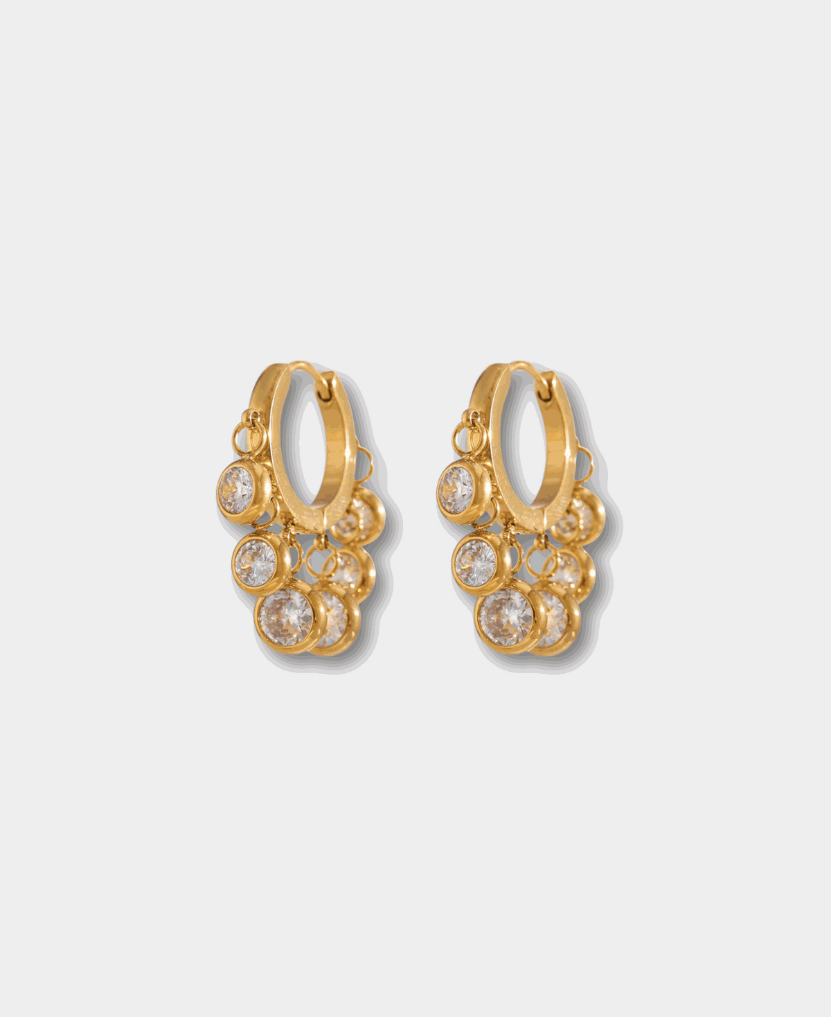 Aurora Hoops in White gold-tone hoop earrings with clustered round clear crystal charms and polished metal settings.