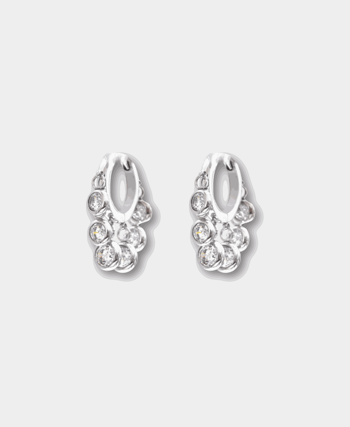 Aurora Hoops in White silver-tone hoop earrings with clustered clear crystal charms and a polished finish.
