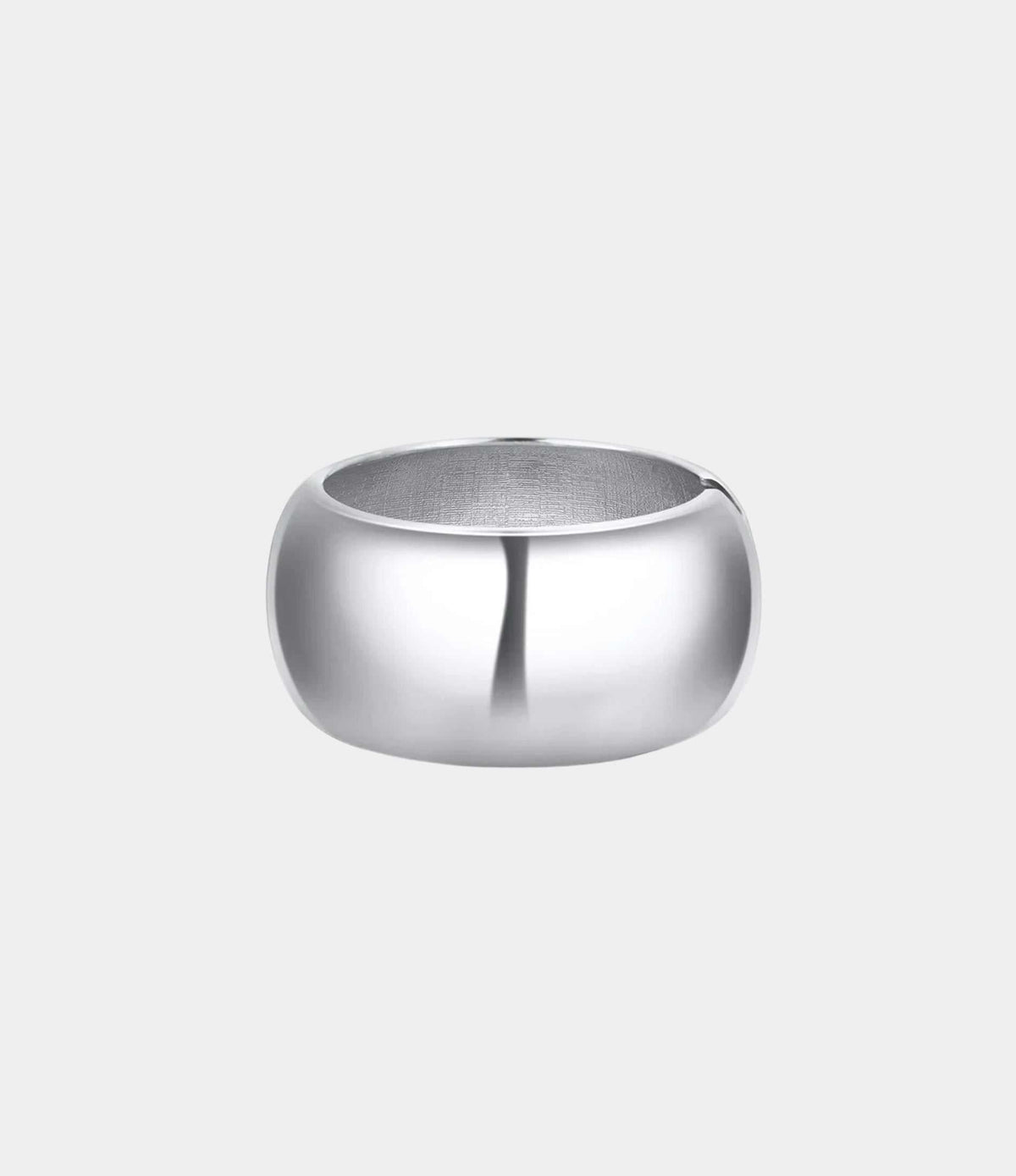CAMILLA BANGLE is a wide, smooth silver-tone metal bangle with a rounded, polished band and open centre.