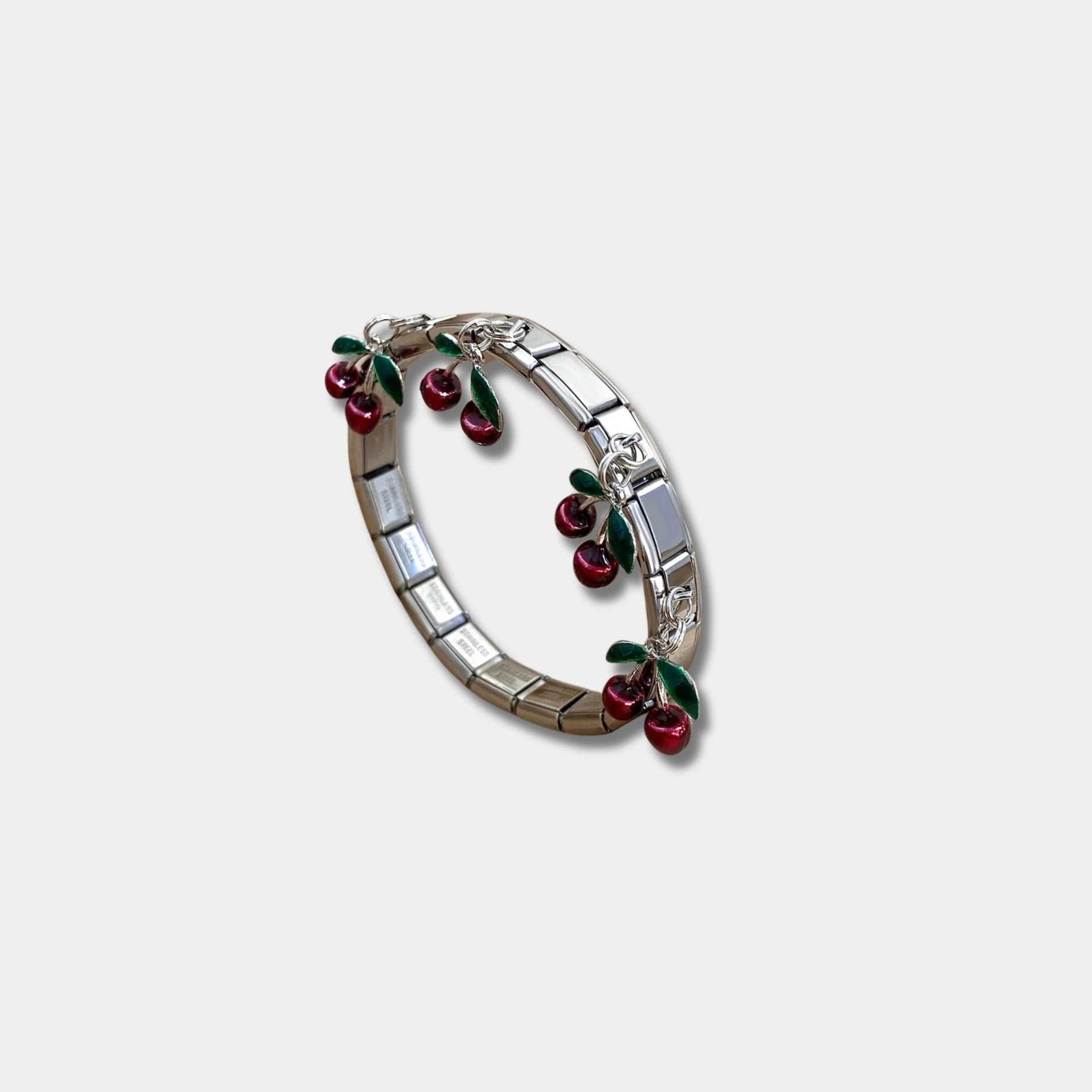 CHERRY ITALIAN CHARM BRACELET in polished silver-tone metal, with linked rectangular panels and glossy red cherry charms with green leaves.
