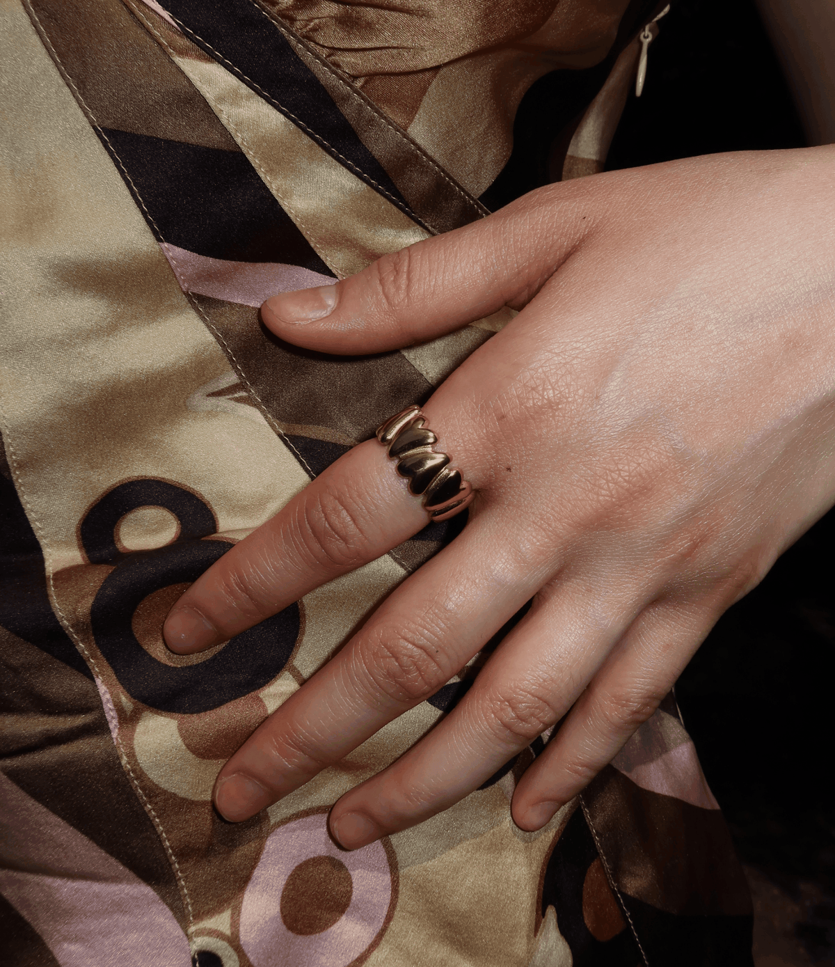MARGO RING gold-tone ring with a sculptural ridged design, worn on a finger
