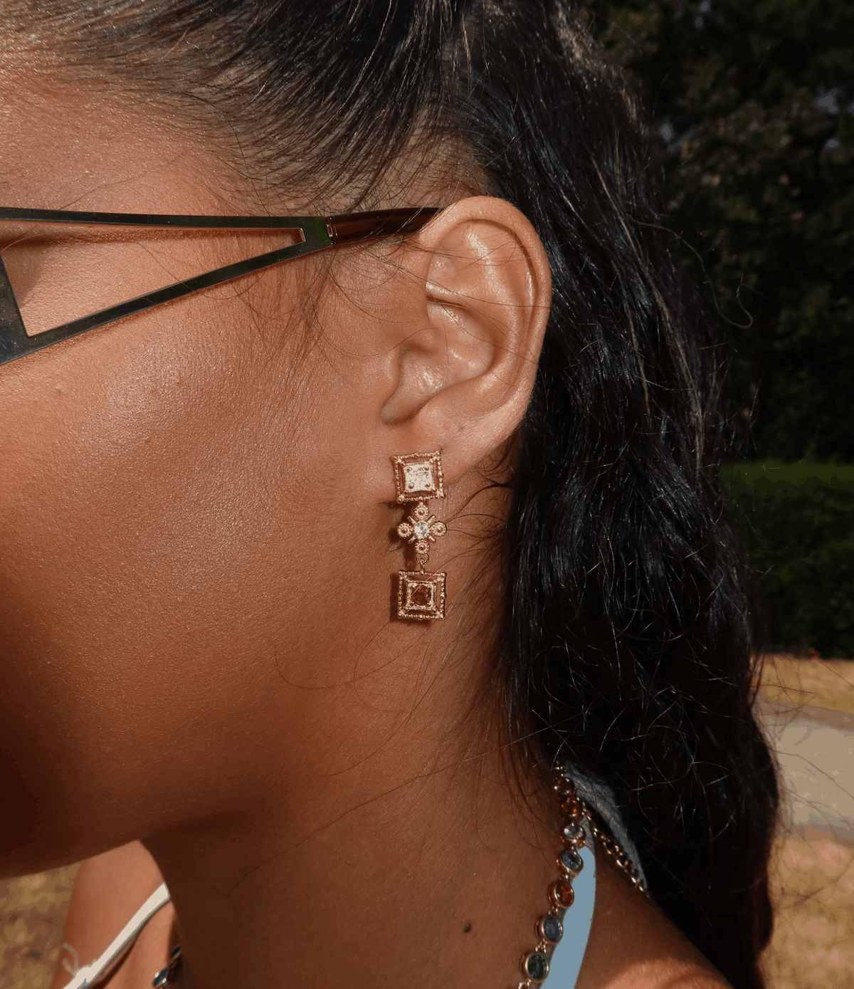 Maria Earrings, gold-toned drop earrings with square frames, clear sparkling stones and delicate floral detailing.