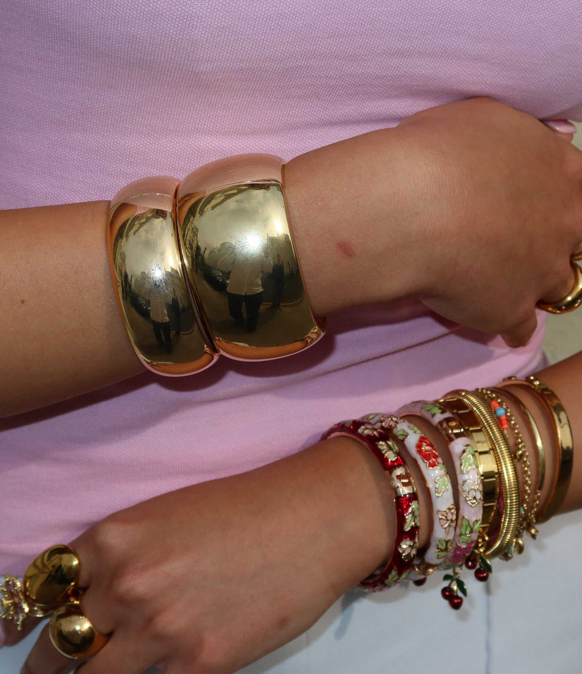 Mindy Bangle, chunky polished gold-tone cuff with a smooth sculptural shape, worn as a bold statement bracelet