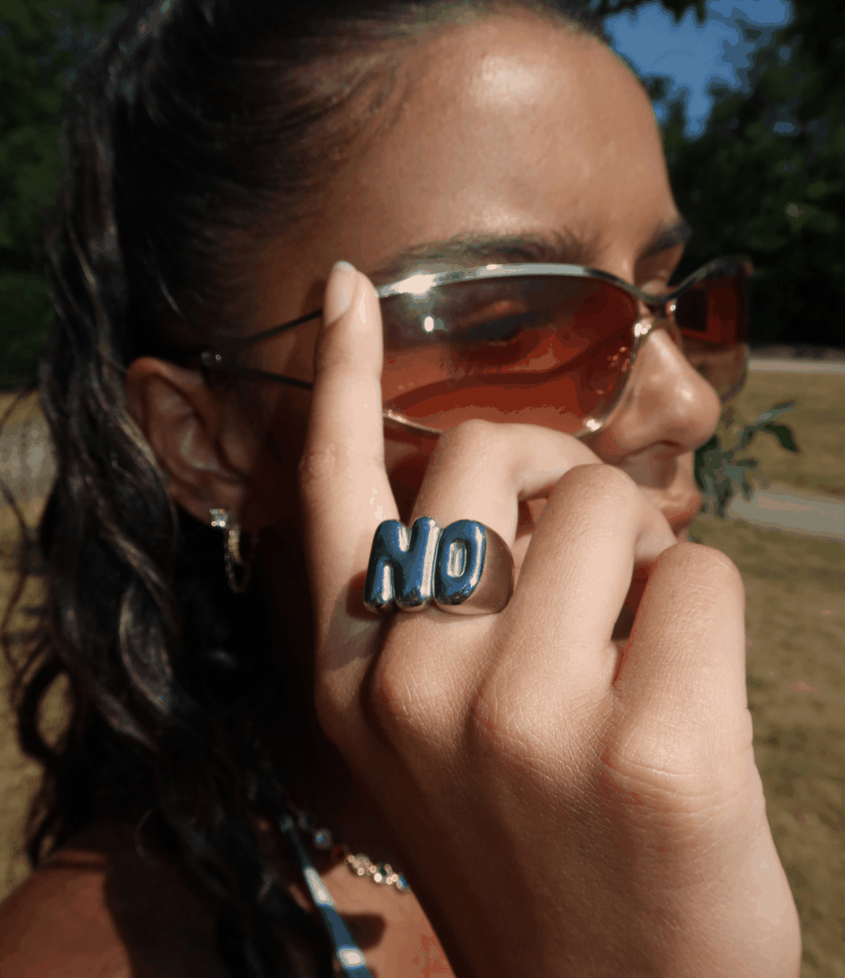 NO RING with bold blue NO lettering on a silver-tone band, worn as a playful statement ring