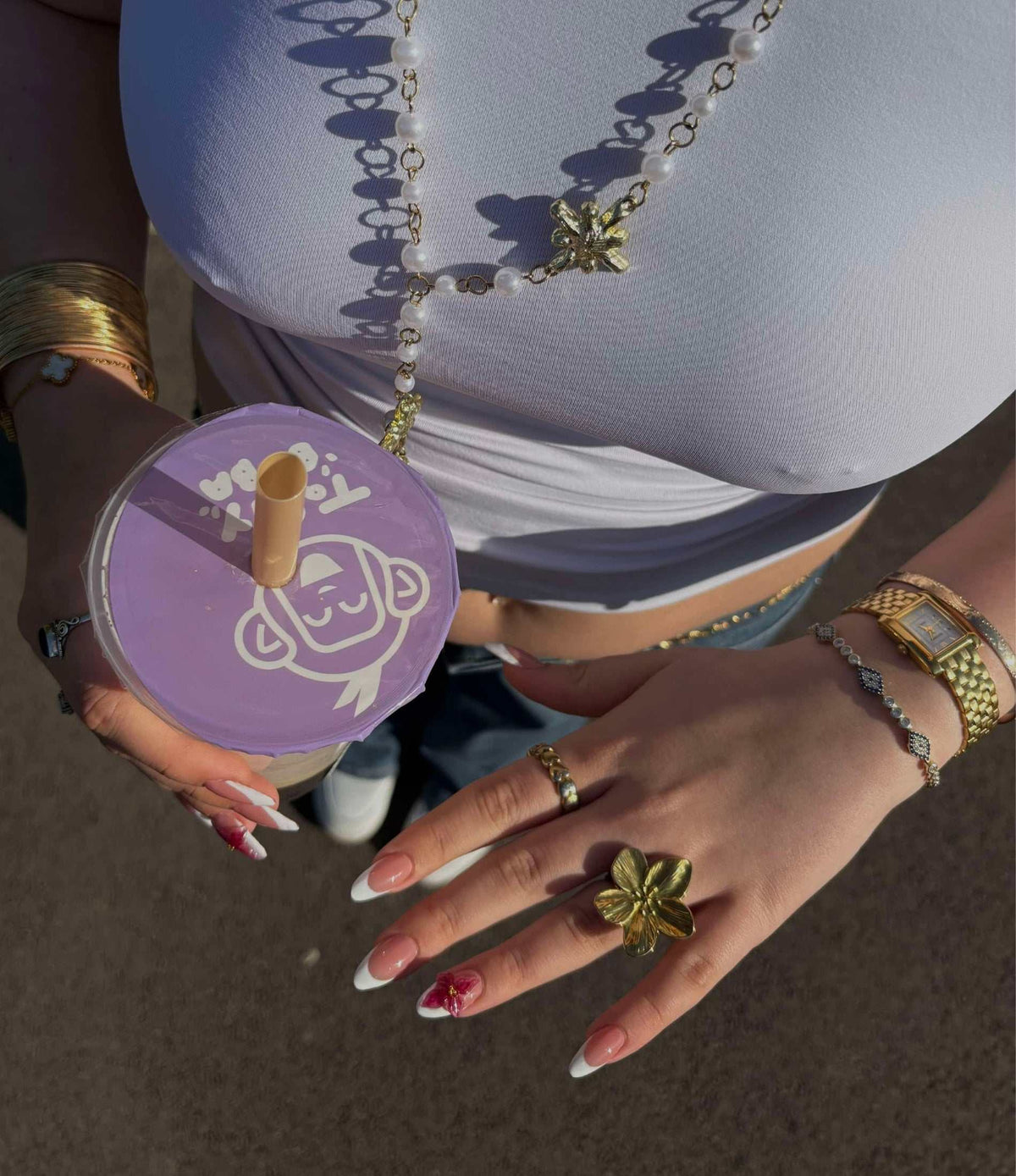 Orchid Affair Ring featuring a gold-tone sculptural flower design with textured petals, worn as a bold statement ring.