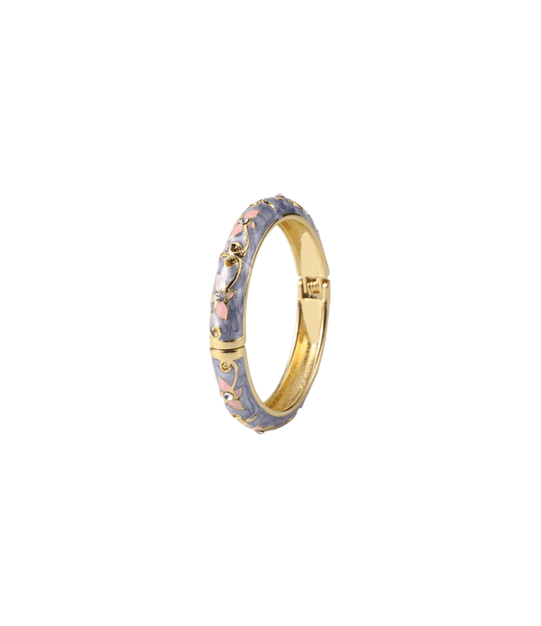 PETIT FLEUR BANGLE with a gold-tone metal band, lavender enamel and pink floral details with sparkling accents.