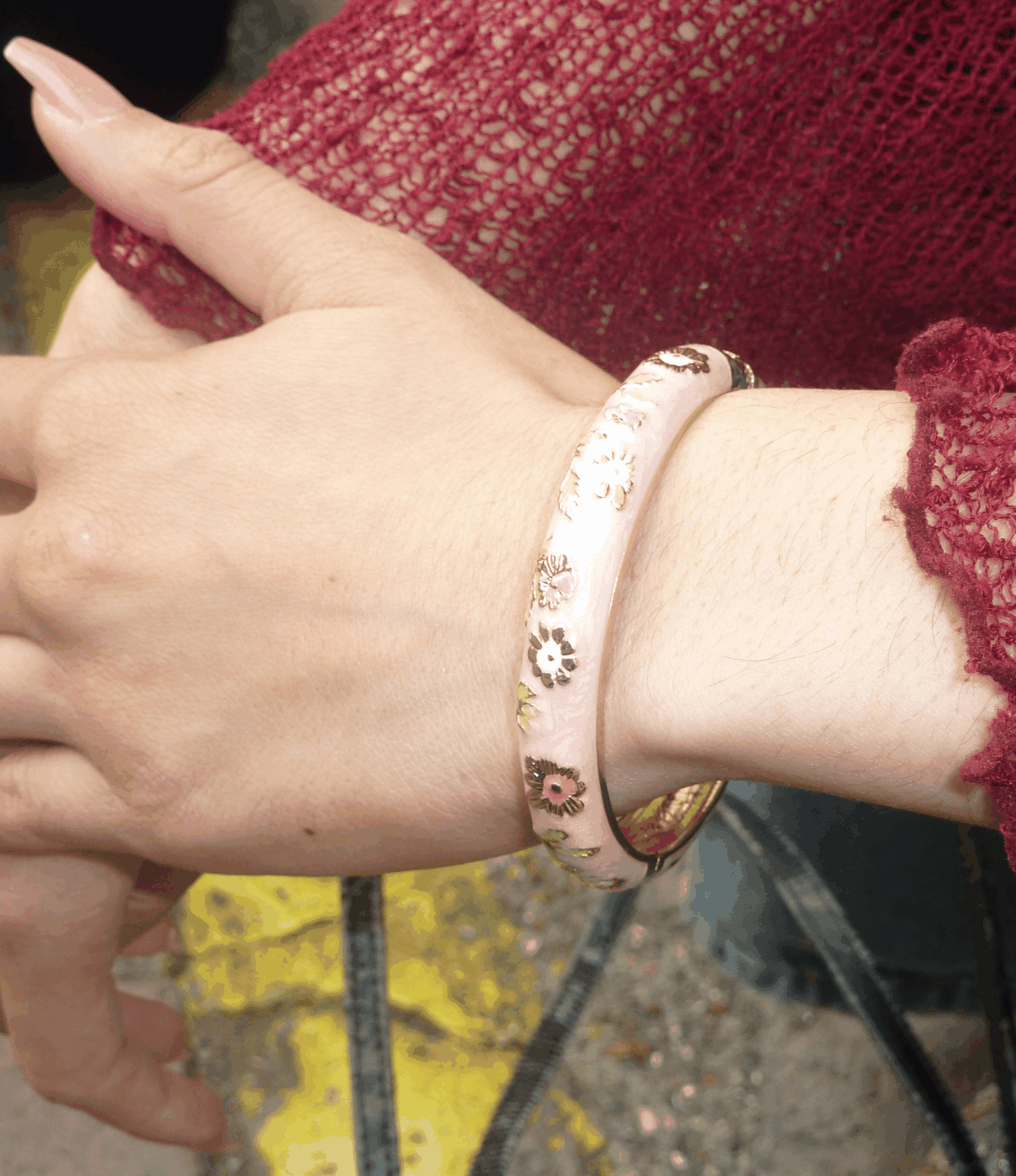 Cloisonné enamel bangle, POPPY BANGLE IN PINK, with a pale pink ground and delicate multicoloured floral details.