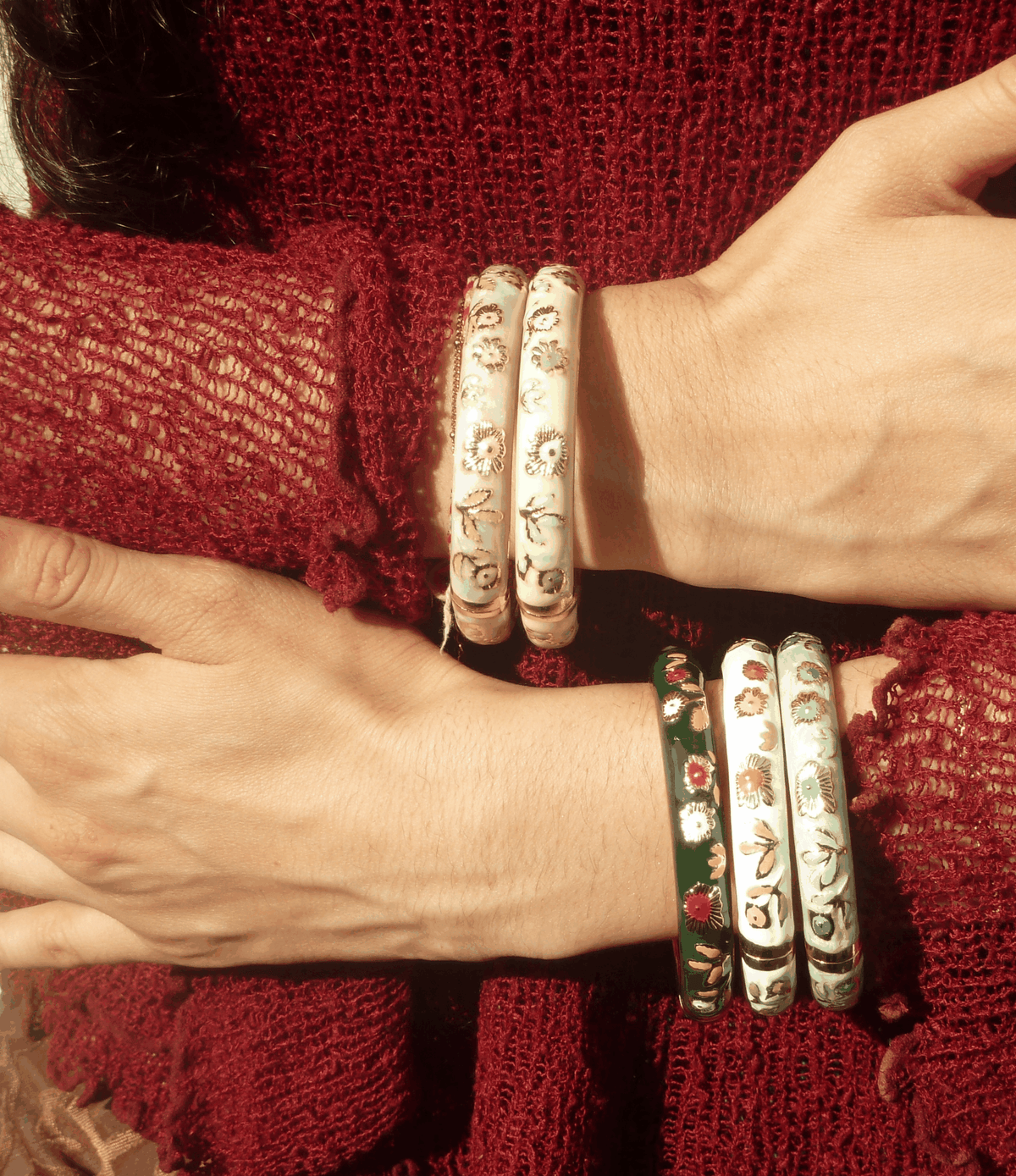 Poppy Enamel Bangle In Lilac - Chinese cloisonné bangle, though the visible bangles are cream and green with floral enamel designs.