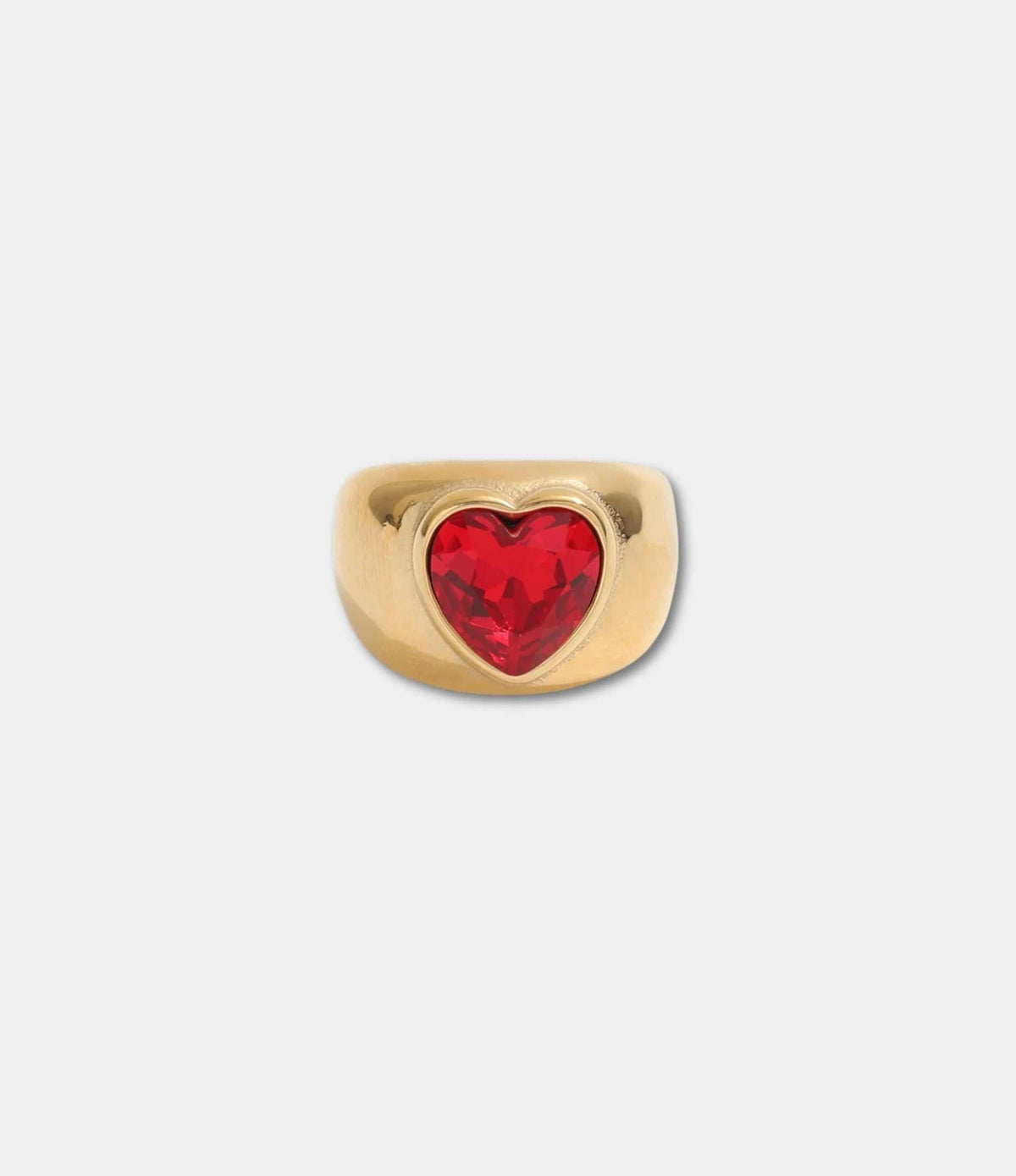 Gold-tone QUEEN OF HEARTS RING with a bold red faceted heart-shaped stone set in a wide polished band.