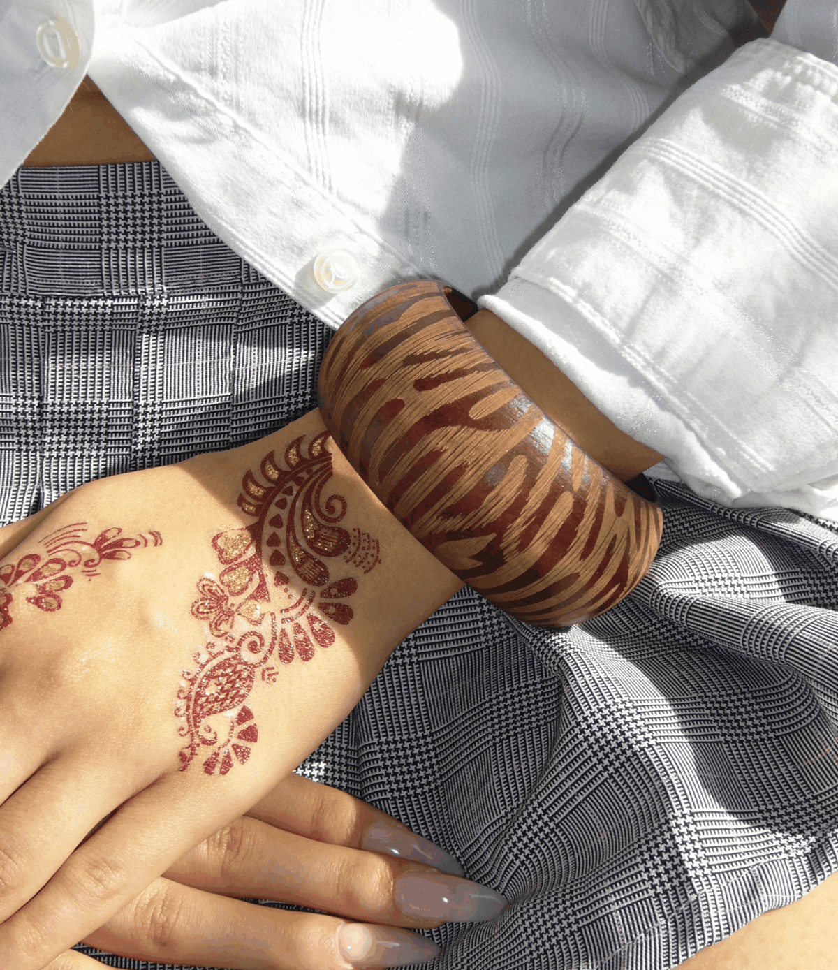 Savannah Wood Bangle in warm auburn wood with a chunky shape and bold zebra-like stripe pattern