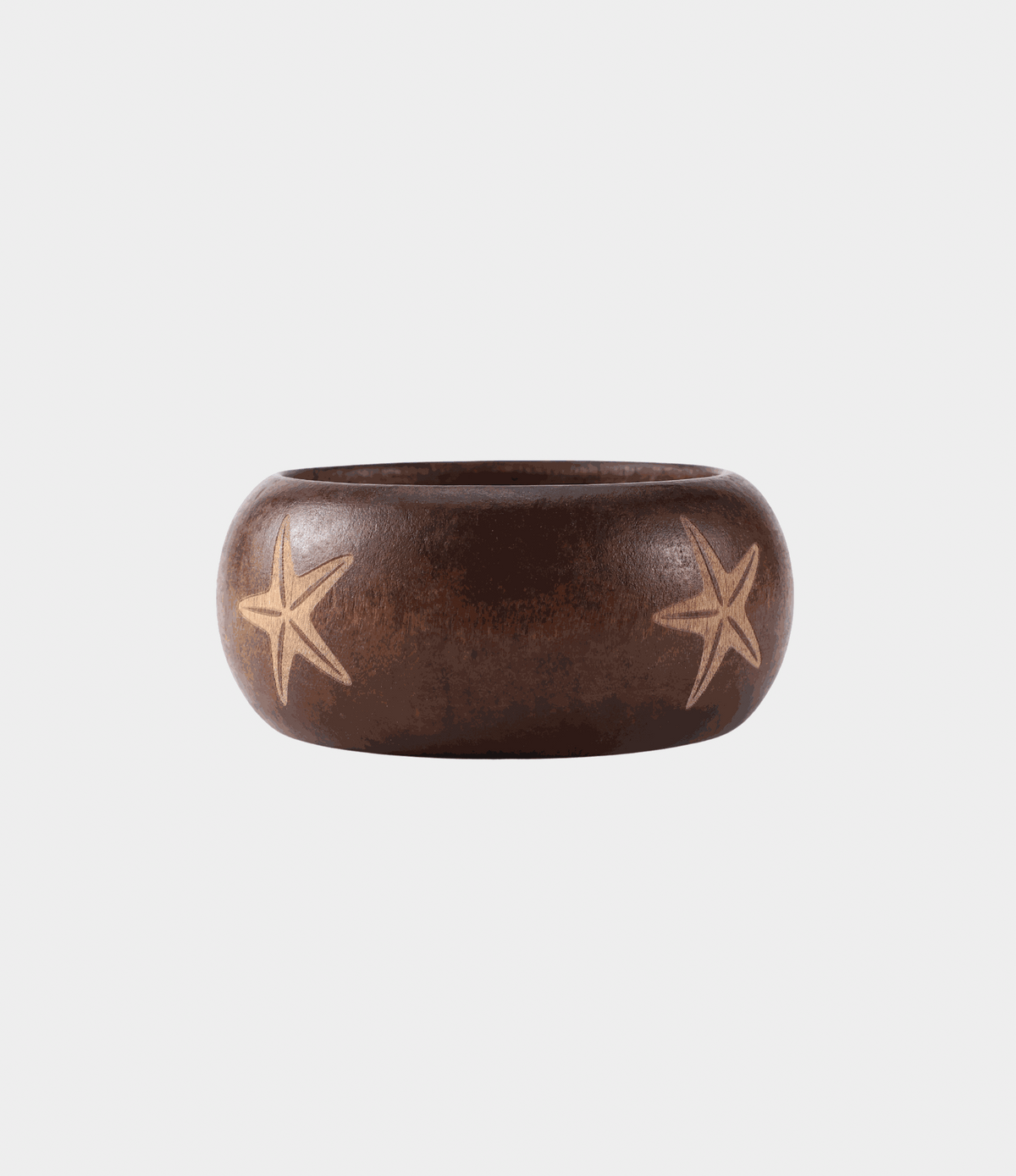 SORAYA WOOD BANGLE in dark auburn wood with a wide rounded shape and pale star motifs