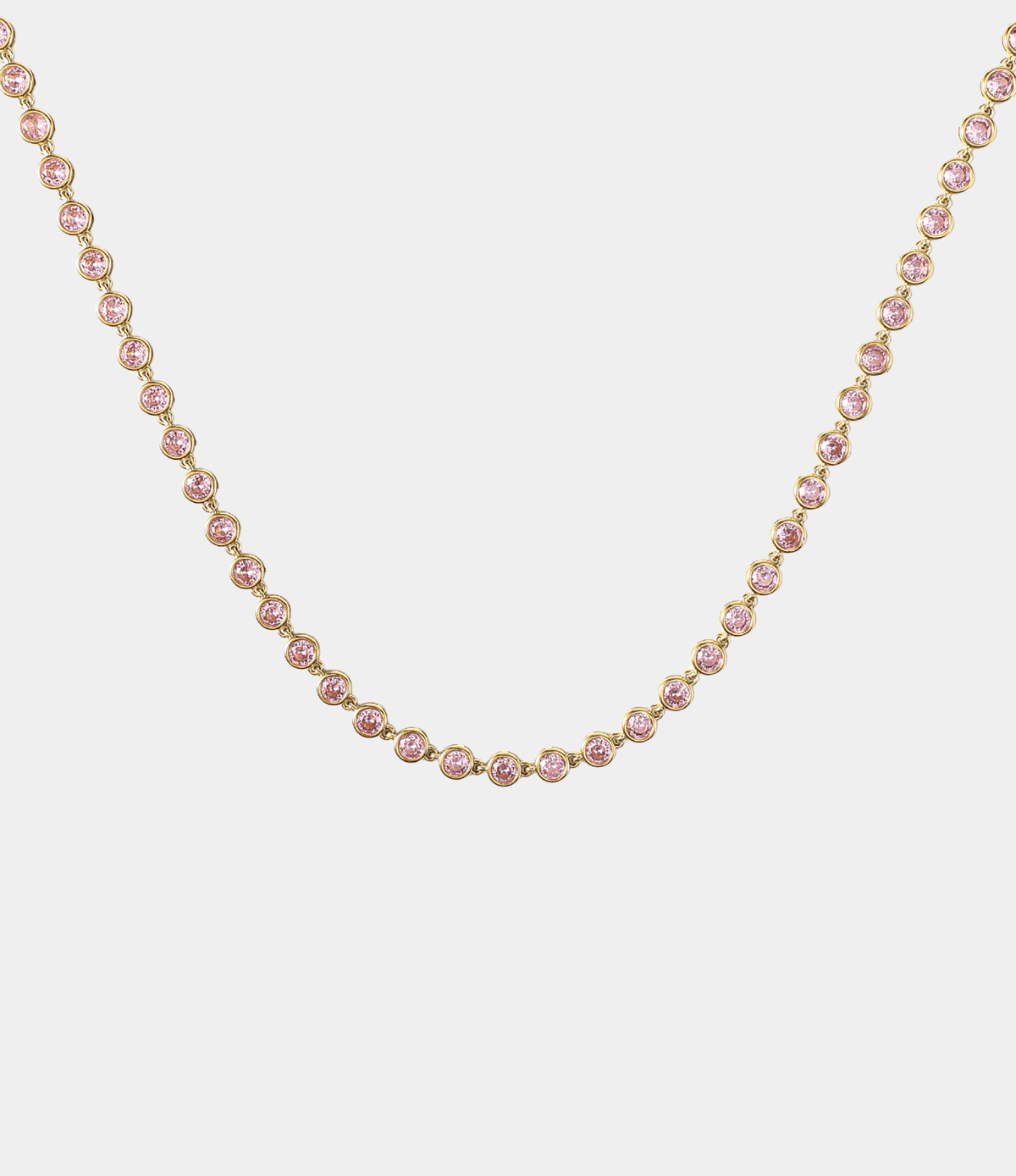 Vivian Tennis Necklace in Pink with a continuous row of round pink stones in polished gold-tone settings