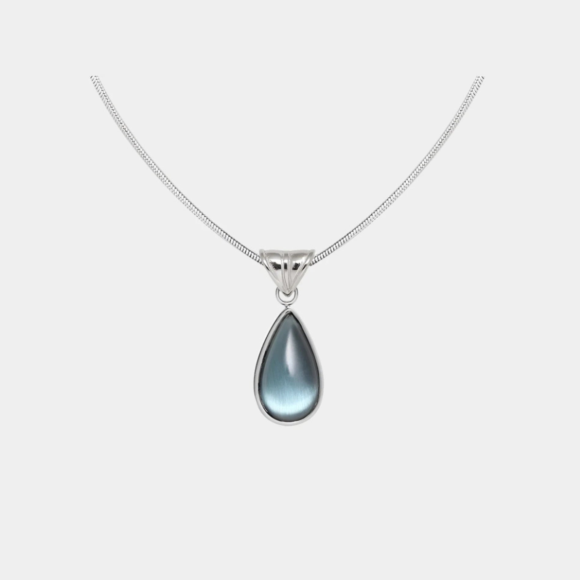 WATER DROP NECKLACE with a silver-tone chain and smooth, blue teardrop pendant in a polished metal setting.